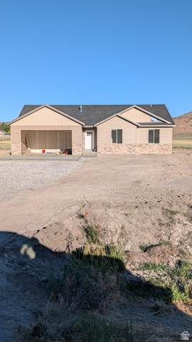 26063 North 8800th West Portage, UT 84331 - Photo 1 of 9 Ranch-style residence featuring a prominent front-facing garage bay and a neutral-toned exterior with stone veneer accents