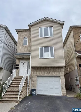 a front view of a house with a garage
