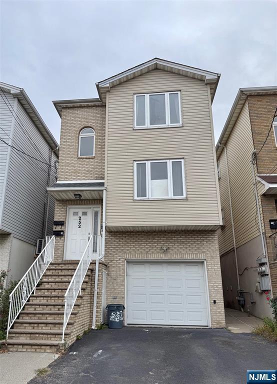 a front view of a house with a garage