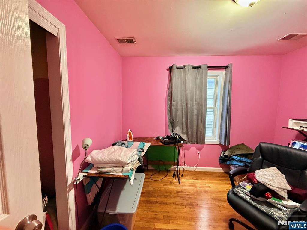 252 Passaic Avenue, Unit 2F East Newark, NJ 07029 - Photo 6 of 11 a bedroom with furniture and a chair