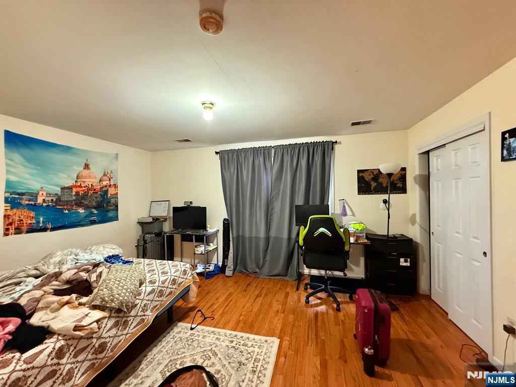 252 Passaic Avenue, Unit 2F East Newark, NJ 07029 - Photo 7 of 11 a living room with furniture and a flat screen tv