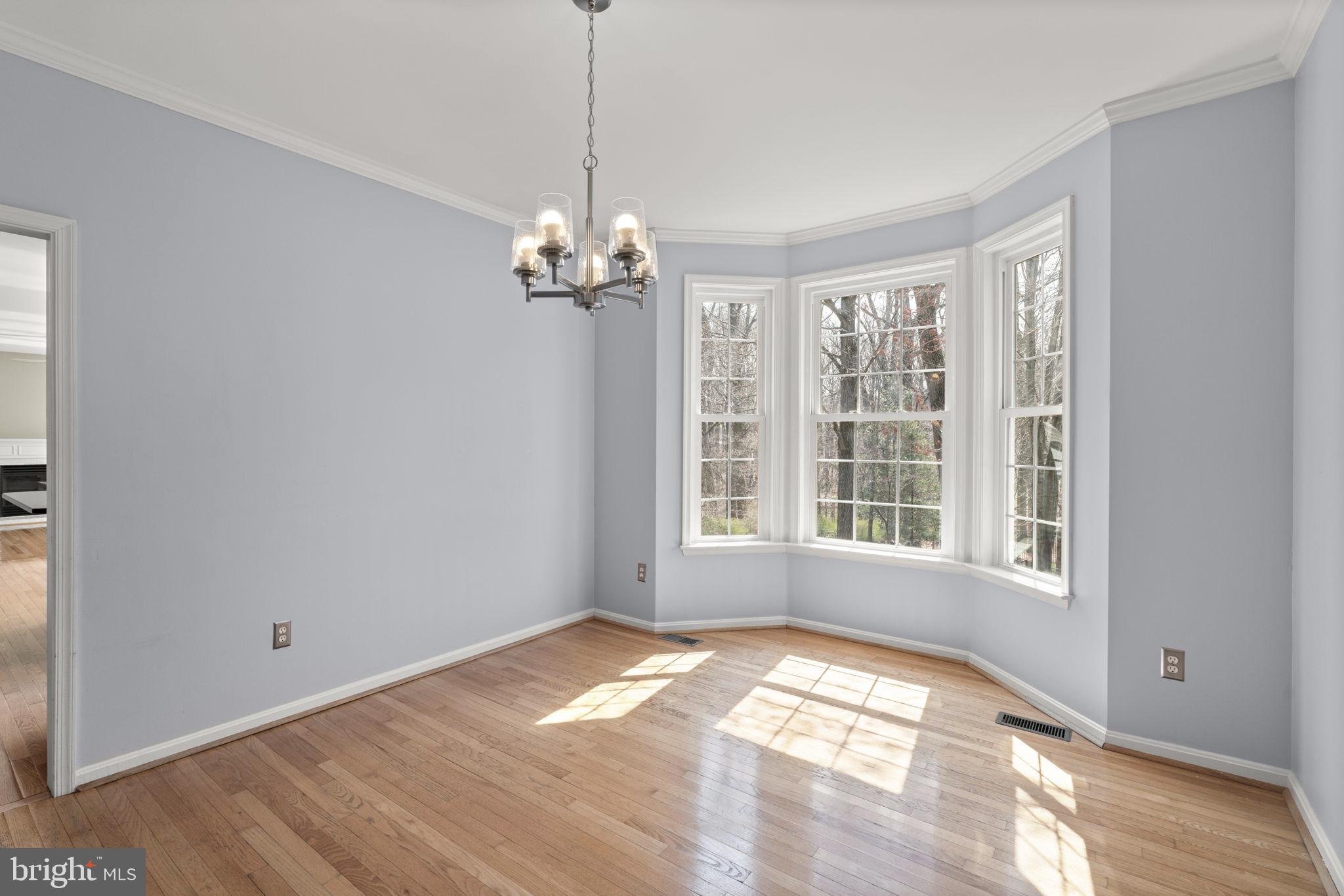 4520 Tulip Way Ellicott City, MD 21043 - Photo 13 of 63 a view of empty room with wooden floor and fan