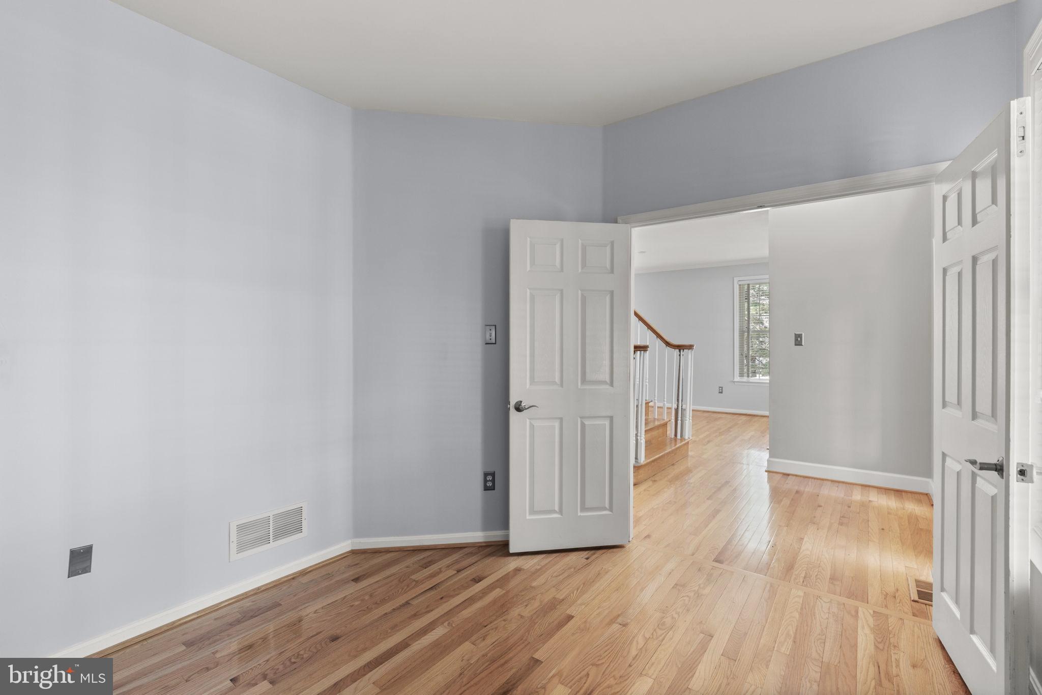 4520 Tulip Way Ellicott City, MD 21043 - Photo 20 of 63 a view of a hallway with wooden floor and staircase