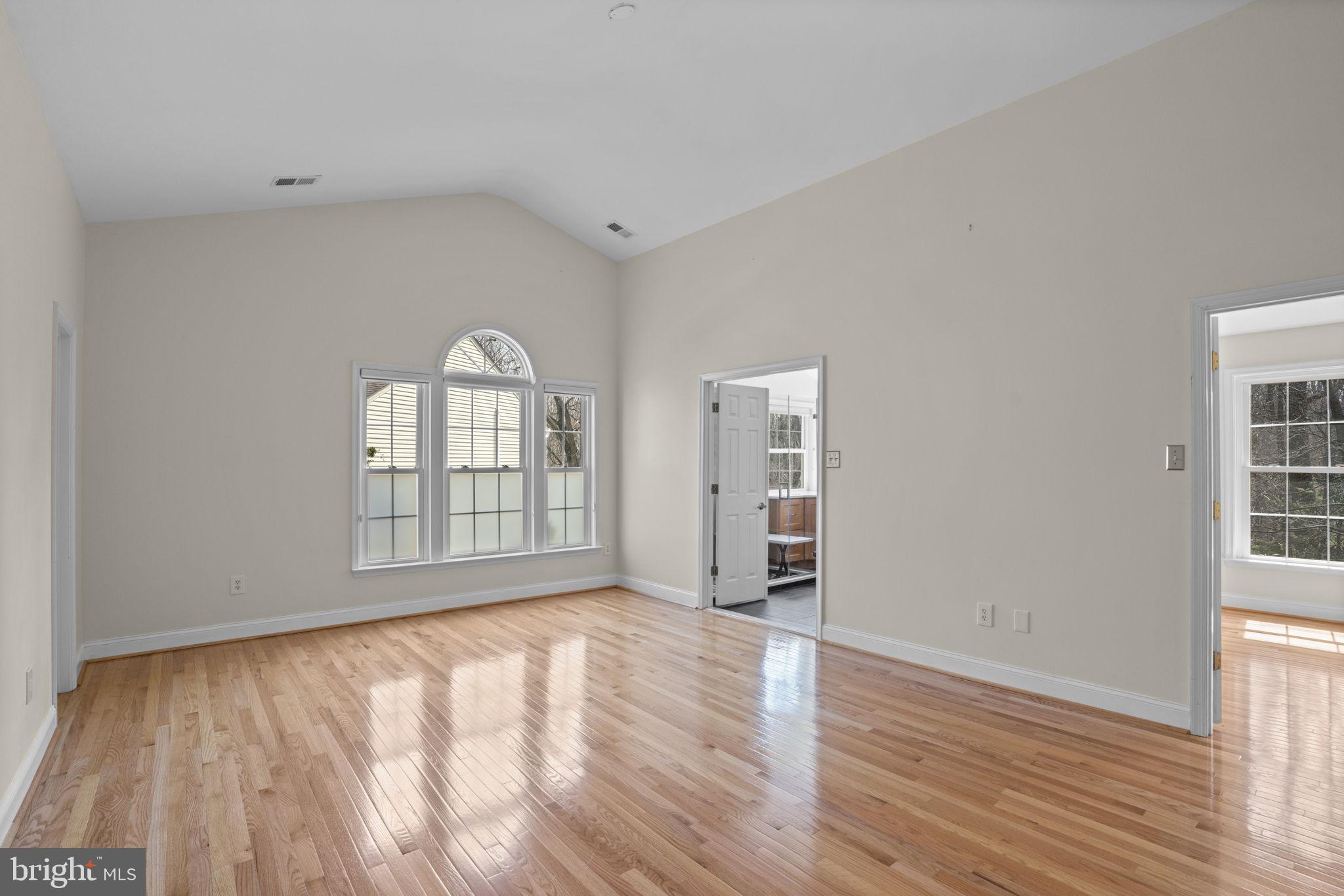 4520 Tulip Way Ellicott City, MD 21043 - Photo 26 of 63 an empty room with wooden floor and windows