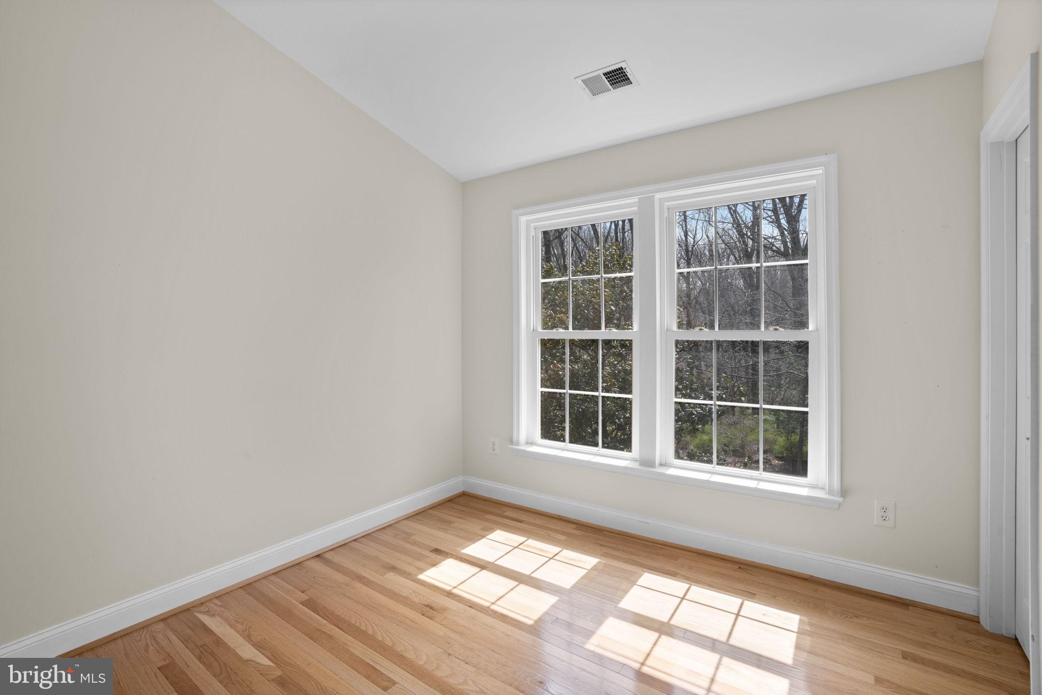 4520 Tulip Way Ellicott City, MD 21043 - Photo 32 of 63 an empty room with wooden floor and windows