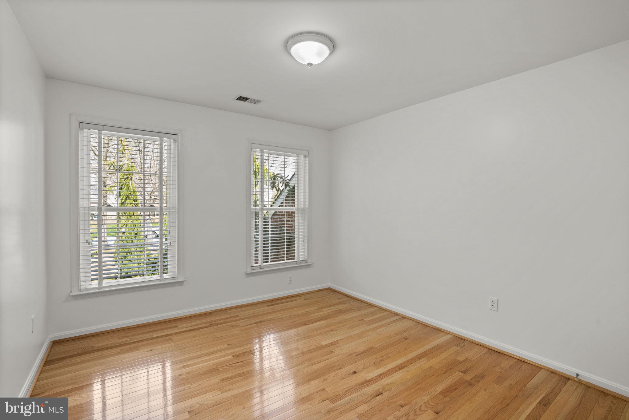 4520 Tulip Way Ellicott City, MD 21043 - Photo 35 of 63 an empty room with wooden floor and windows