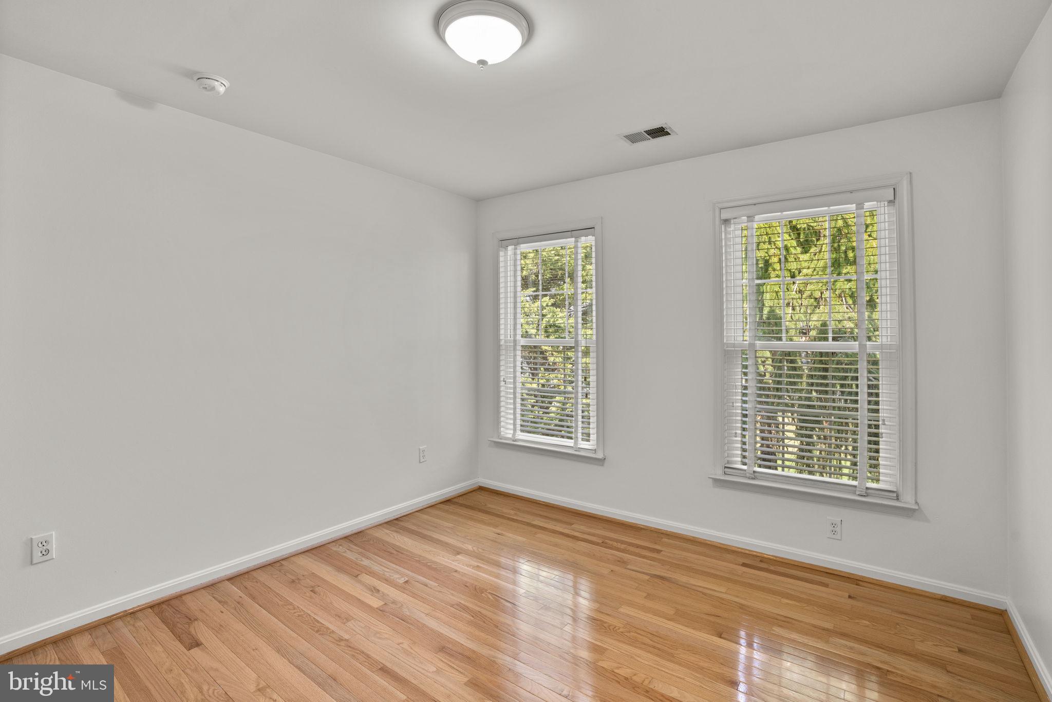 4520 Tulip Way Ellicott City, MD 21043 - Photo 36 of 63 a view of an empty room with wooden floor and a window