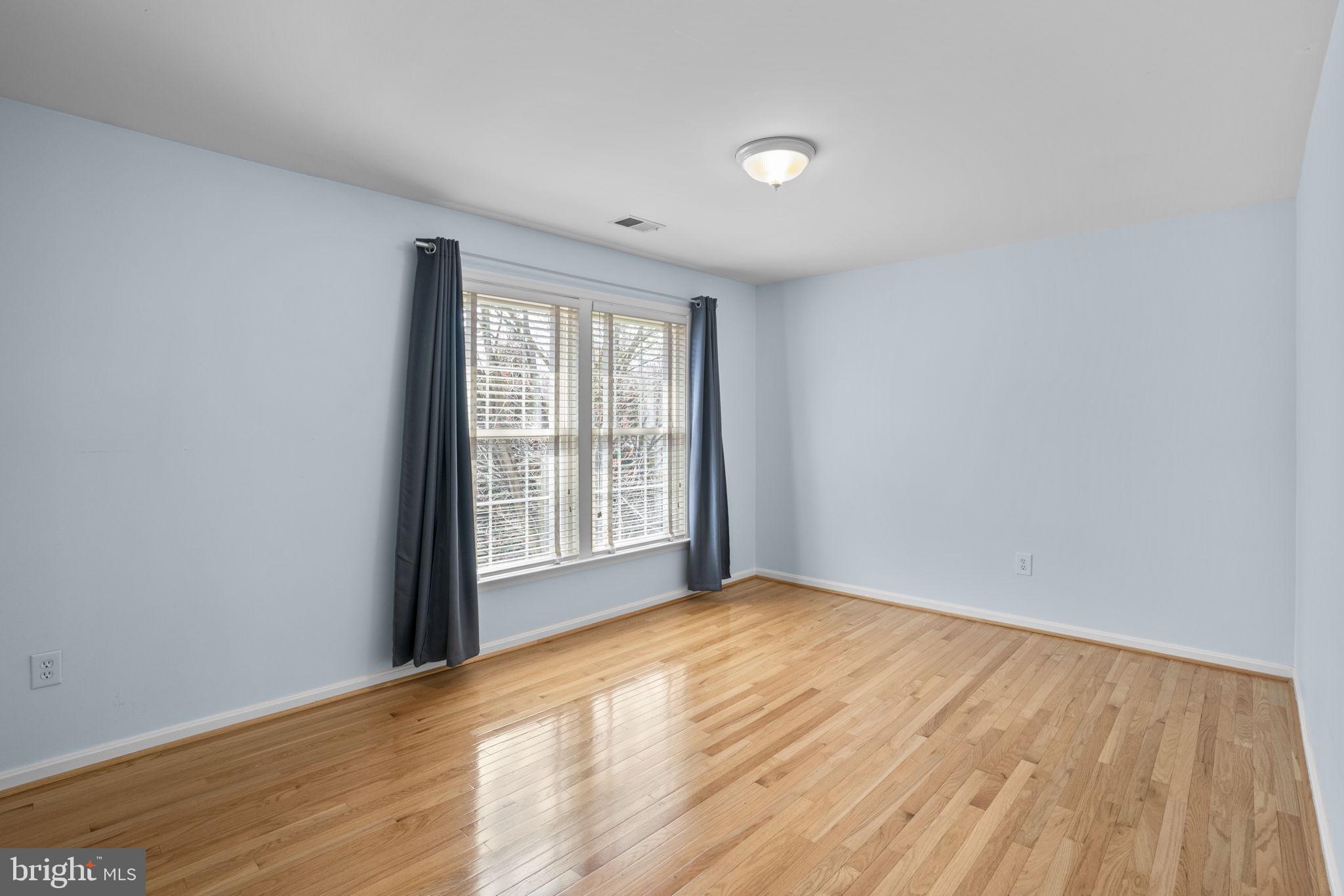4520 Tulip Way Ellicott City, MD 21043 - Photo 38 of 63 a view of an empty room with wooden floor and a window