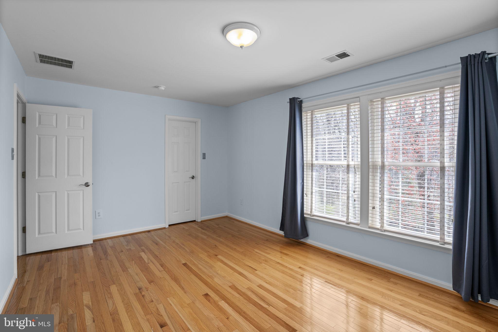 4520 Tulip Way Ellicott City, MD 21043 - Photo 39 of 63 a view of an empty room with wooden floor and a window