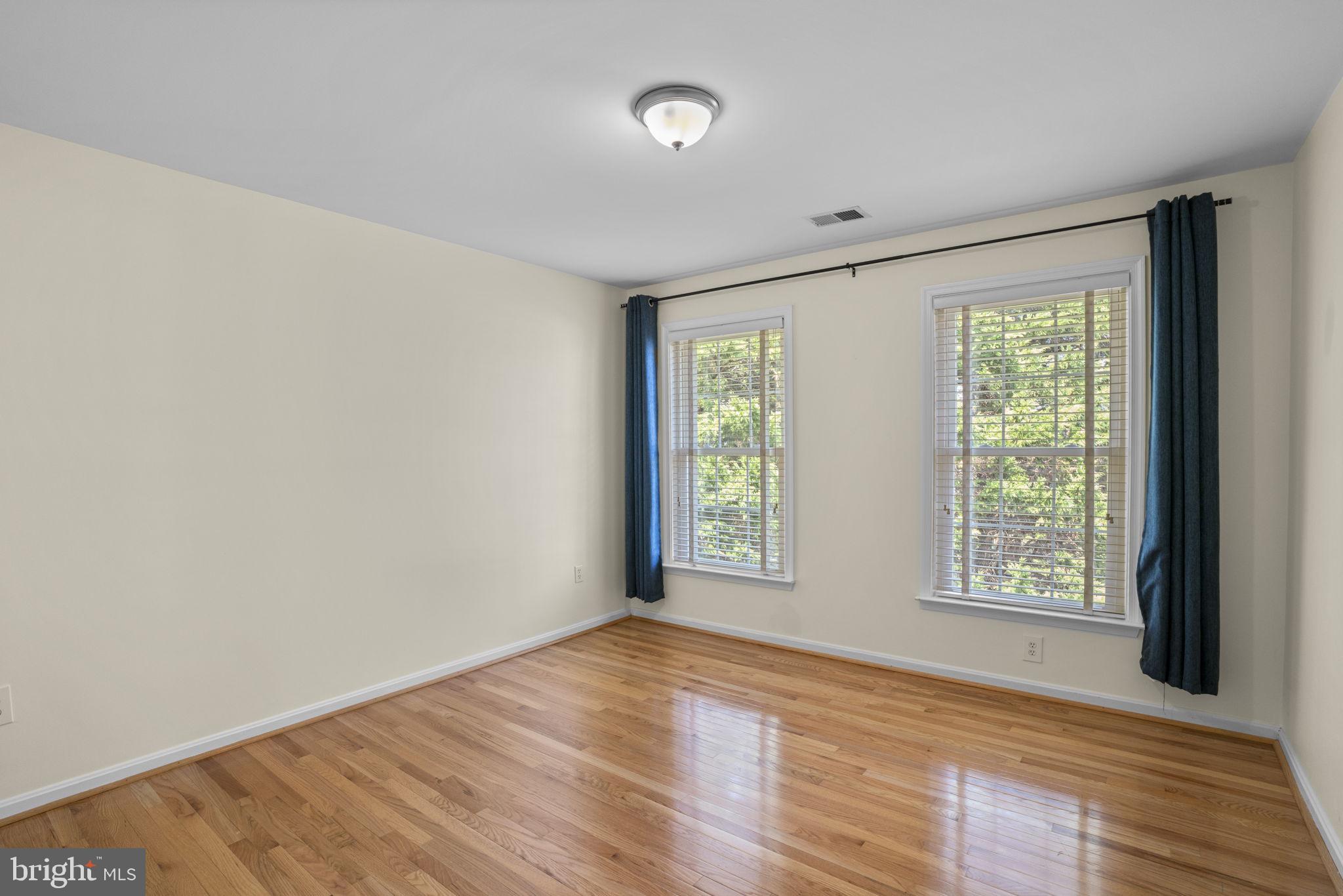 4520 Tulip Way Ellicott City, MD 21043 - Photo 41 of 63 an empty room with wooden floor and windows