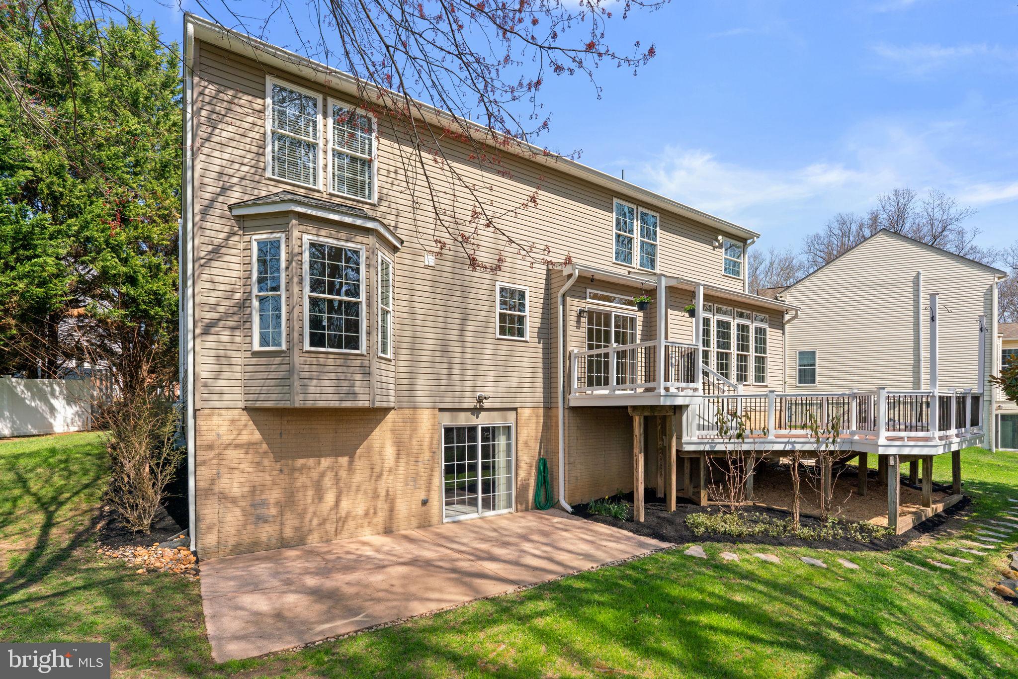 4520 Tulip Way Ellicott City, MD 21043 - Photo 57 of 63 a front view of a building with glass windows and a yard