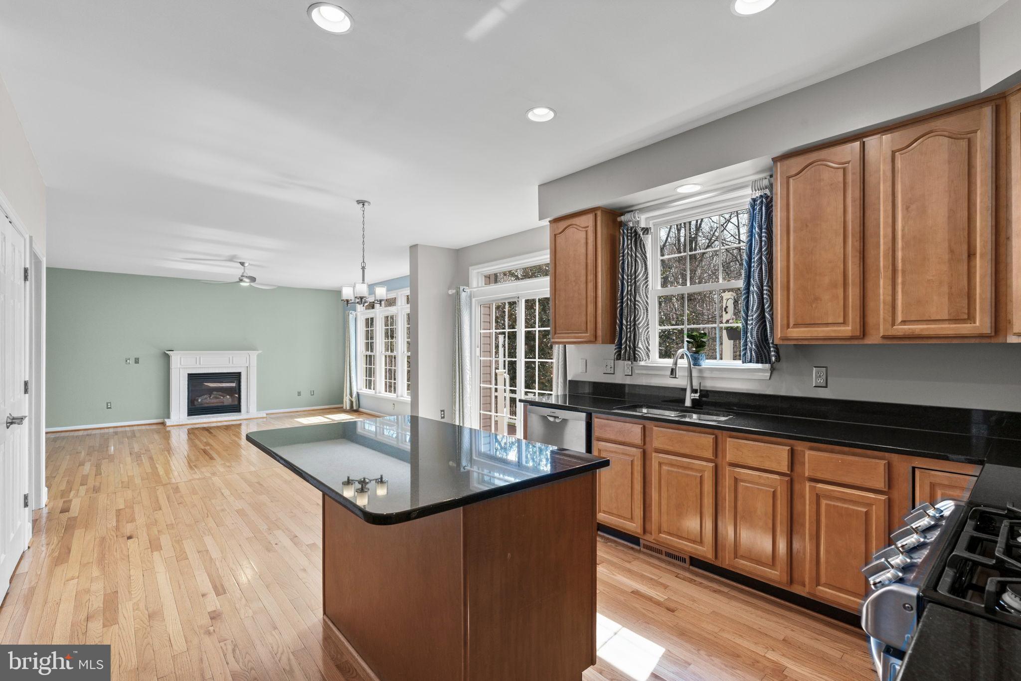4520 Tulip Way Ellicott City, MD 21043 - Photo 6 of 63 a kitchen with granite countertop a sink stove and cabinets