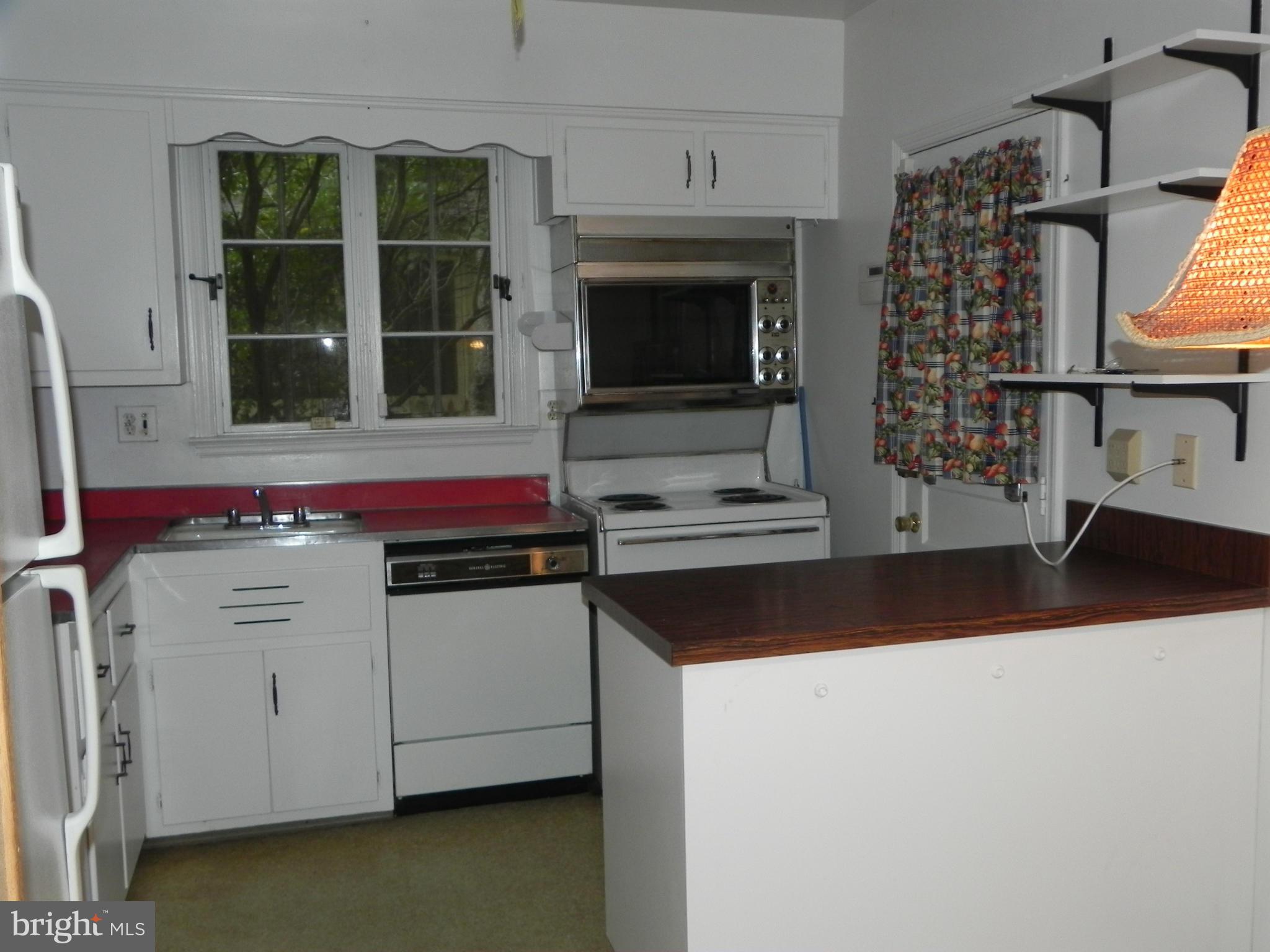 5427 Springlake Way Baltimore, MD 21212 - Photo 8 of 18 a kitchen with stainless steel appliances a stove and a microwave