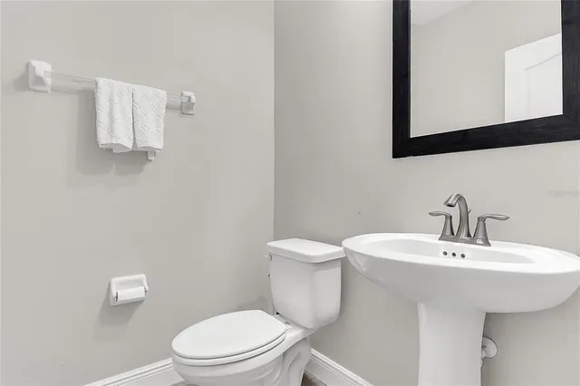 a bathroom with a sink a mirror and a toilet