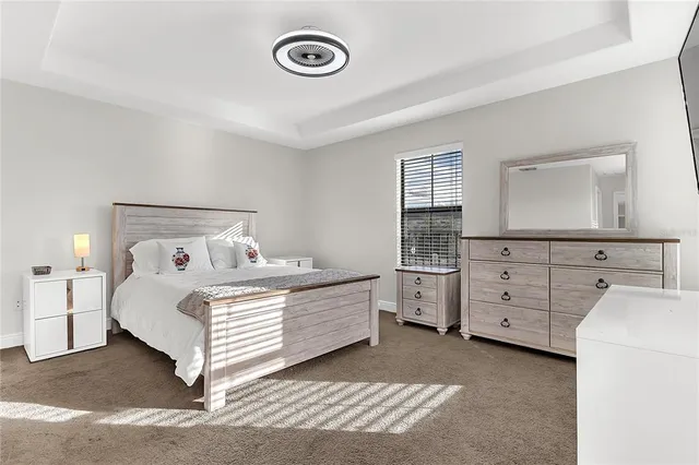 a room with a bed and a dresser
