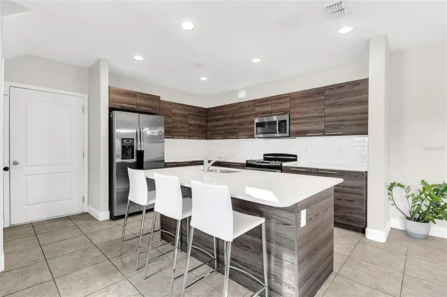 a kitchen with a sink and refrigerator