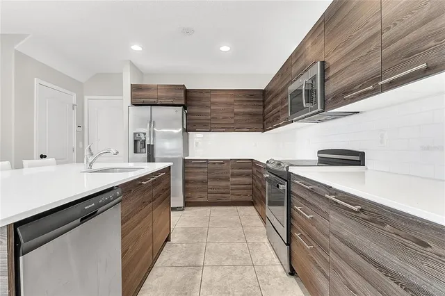a kitchen with stainless steel appliances granite countertop a sink and cabinets