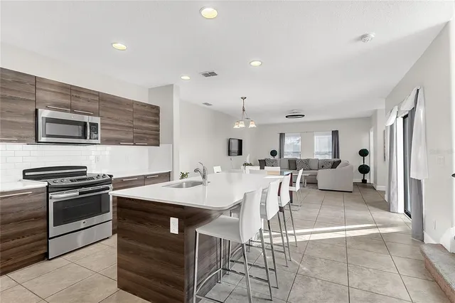 a kitchen with a sink counter top space appliances and cabinets