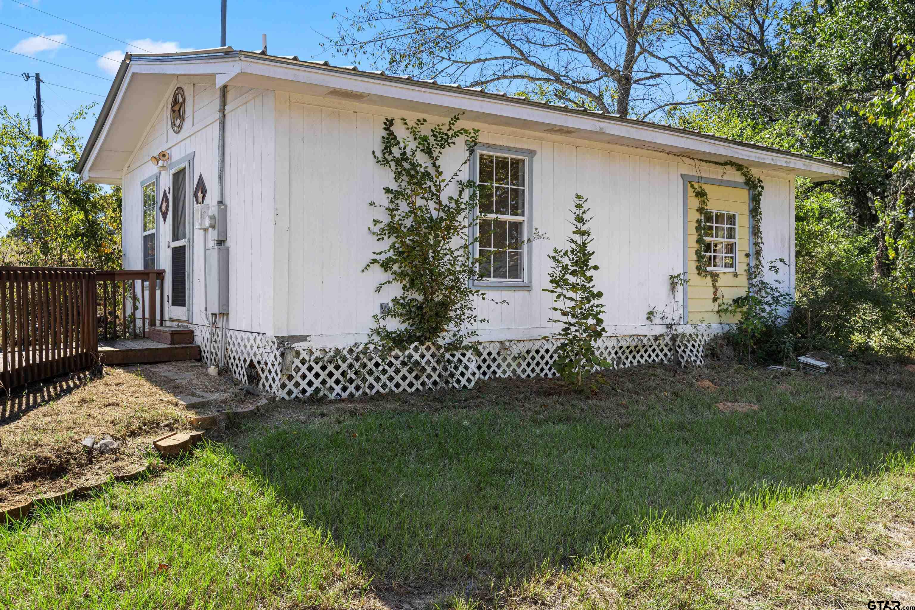 1159 County Road Mount Enterprise, TX 75681 - Photo 18 of 27 a front view of a house with a garden