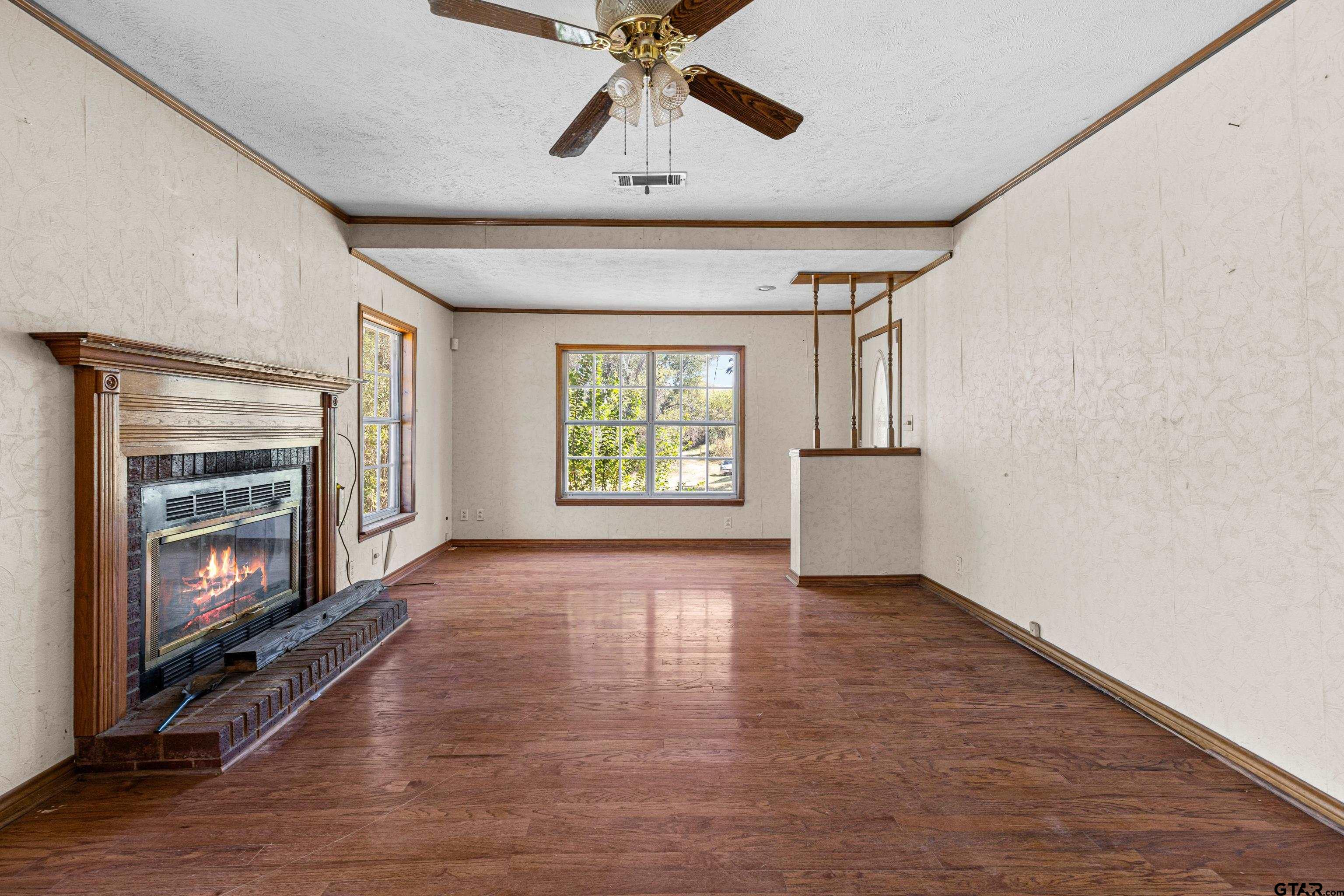 1159 County Road Mount Enterprise, TX 75681 - Photo 5 of 27 a view of an empty room with a fireplace and a window