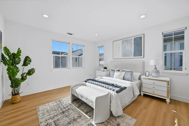 a bedroom with a bed and a painting on the wall