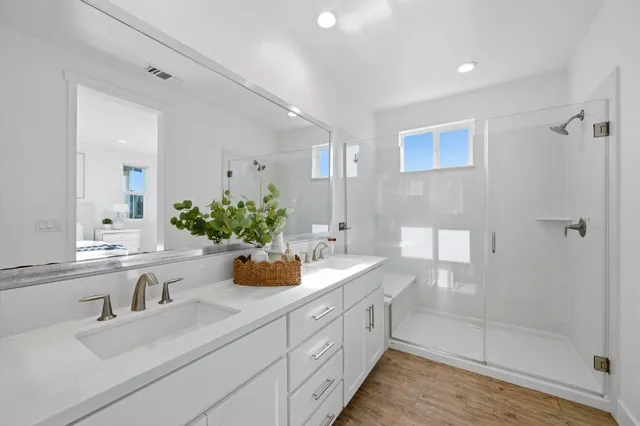 a bathroom with a tub shower and sink