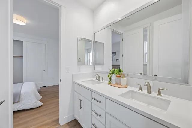 a bedroom with a bed and wooden floor