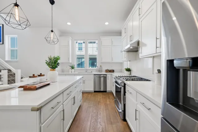 a kitchen with a sink stove and cabinets
