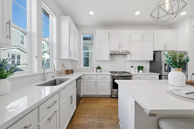 a kitchen with a sink stove and cabinets