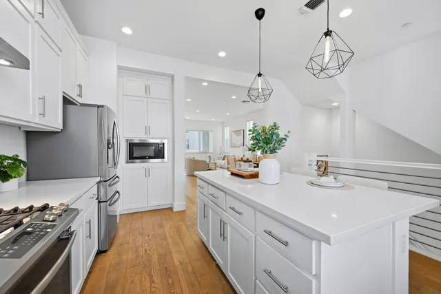 a kitchen with cabinets a sink and appliances