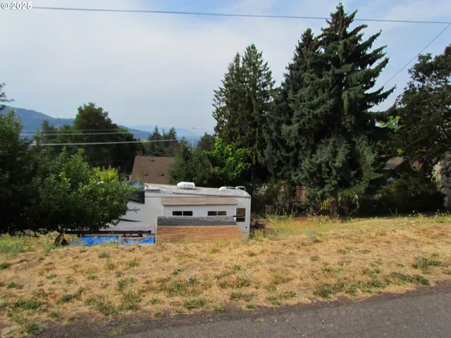 a backyard of a house with table and chairs