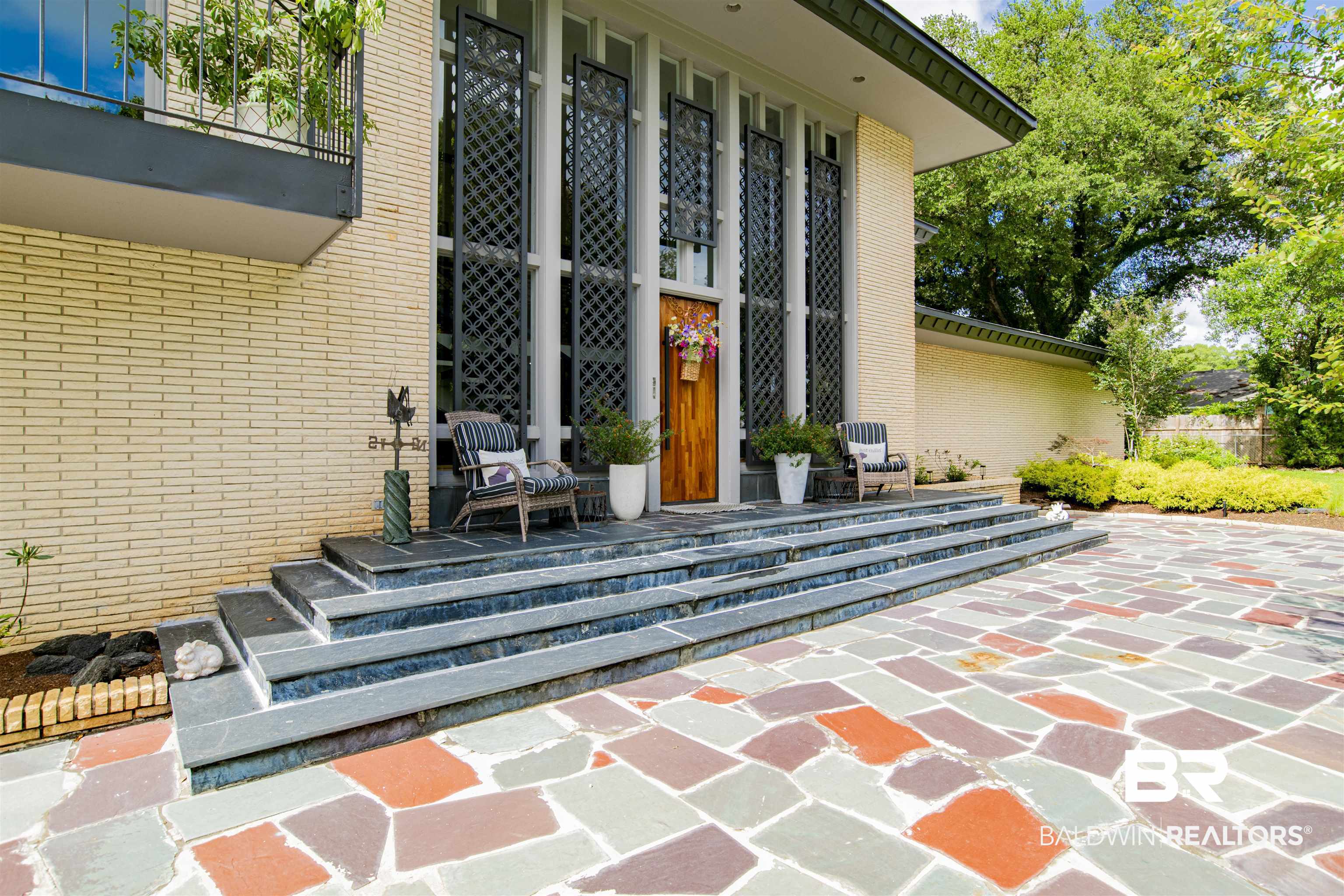 809 Bernard Circle Mobile, AL 36693 - Photo 8 of 75 Foyer entry featuring a wood door, slate steps, and decorative lattice panels