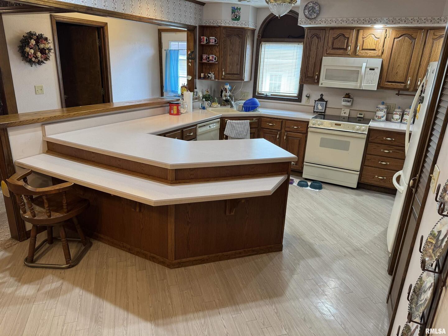 8424 Bolen Store Road Thompsonville, IL 62890 - Photo 11 of 30 a kitchen with stainless steel appliances a sink stove and a refrigerator
