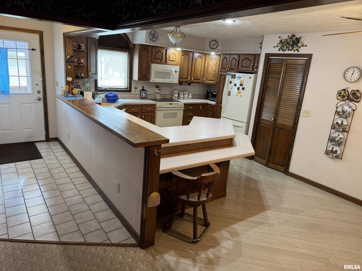 8424 Bolen Store Road Thompsonville, IL 62890 - Photo 12 of 30 a dining hall with stainless steel appliances kitchen island granite countertop furniture and a window