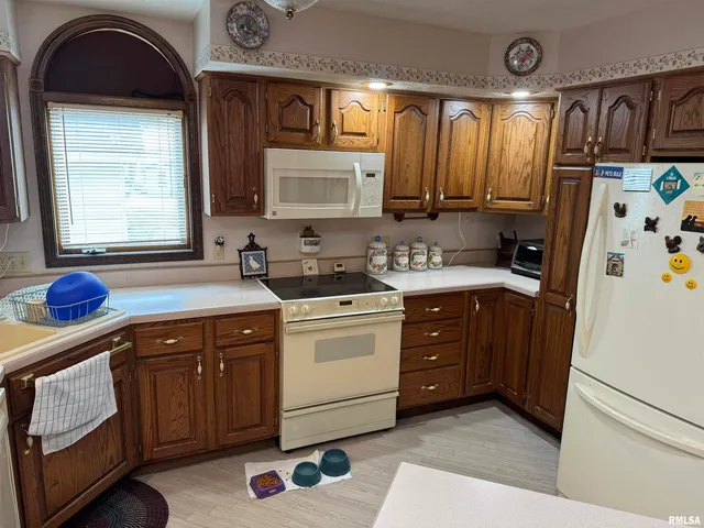 a utility room with sink dryer and washer