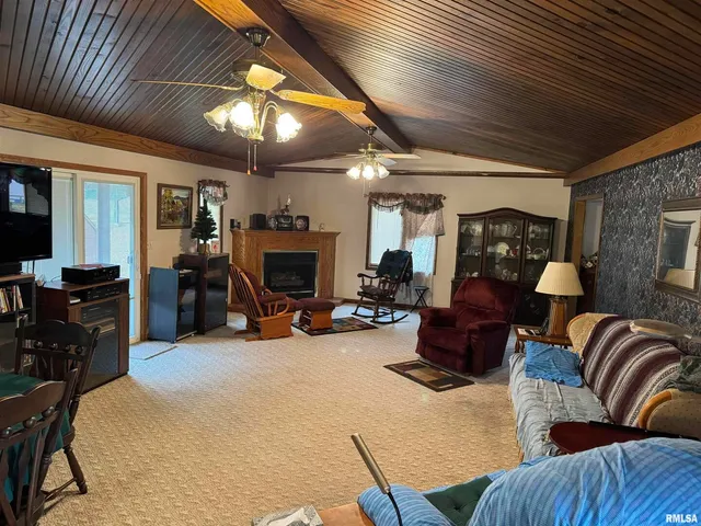 a living room with furniture a fireplace and a chandelier