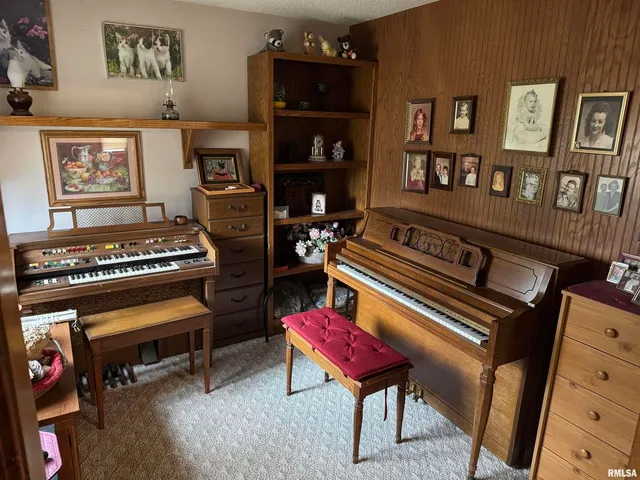a bedroom with furniture and a piano