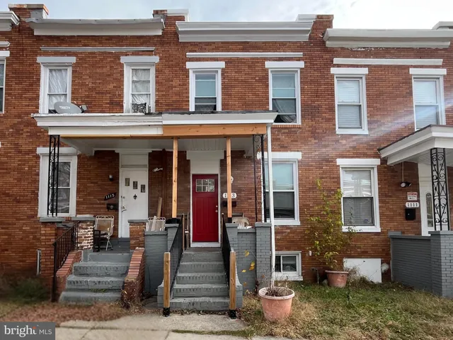 front view of a brick house with a large windows