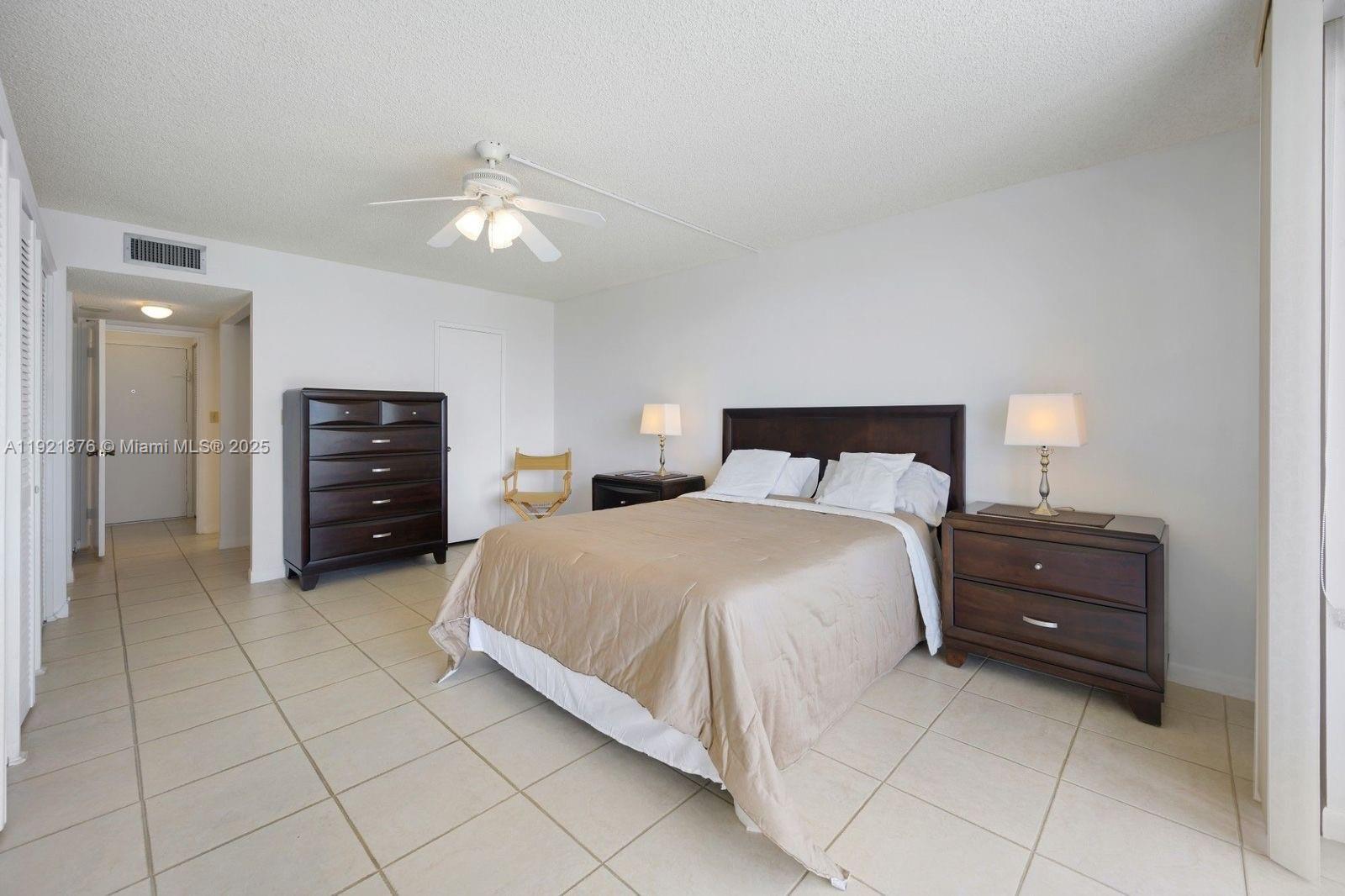 2851 Northeast 183rd Street, Unit 502E Aventura, FL 33160 - Photo 16 of 25 a bedroom with a bed and cabinets