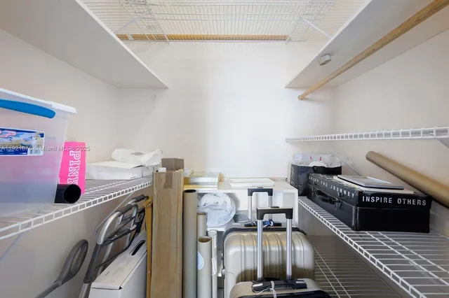 a view of storage and utility room with racks on the wall