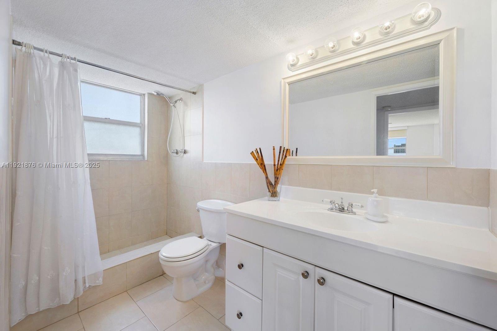 2851 Northeast 183rd Street, Unit 502E Aventura, FL 33160 - Photo 19 of 25 a bathroom with a sink a toilet and shower