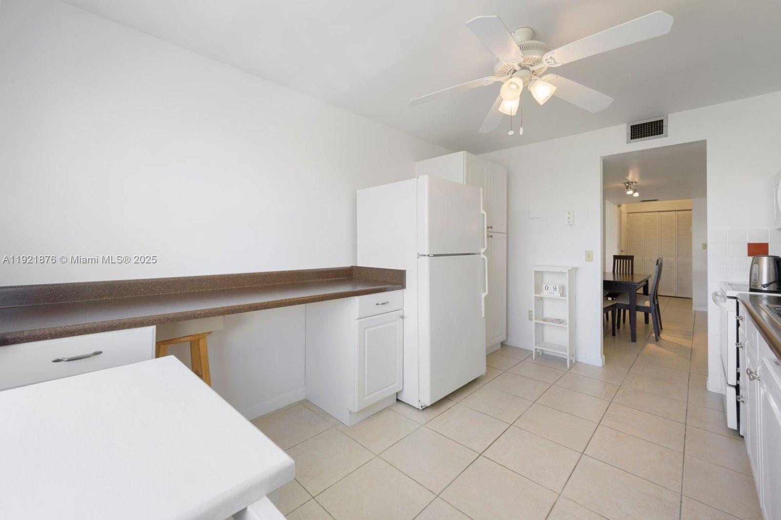 2851 Northeast 183rd Street, Unit 502E Aventura, FL 33160 - Photo 23 of 25 a view of kitchen with furniture and a ceiling fan