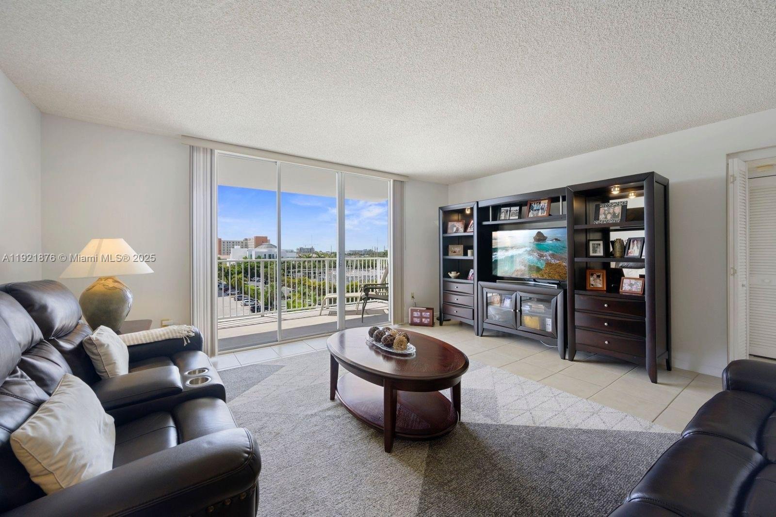 2851 Northeast 183rd Street, Unit 502E Aventura, FL 33160 - Photo 9 of 25 a living room with furniture and a floor to ceiling window