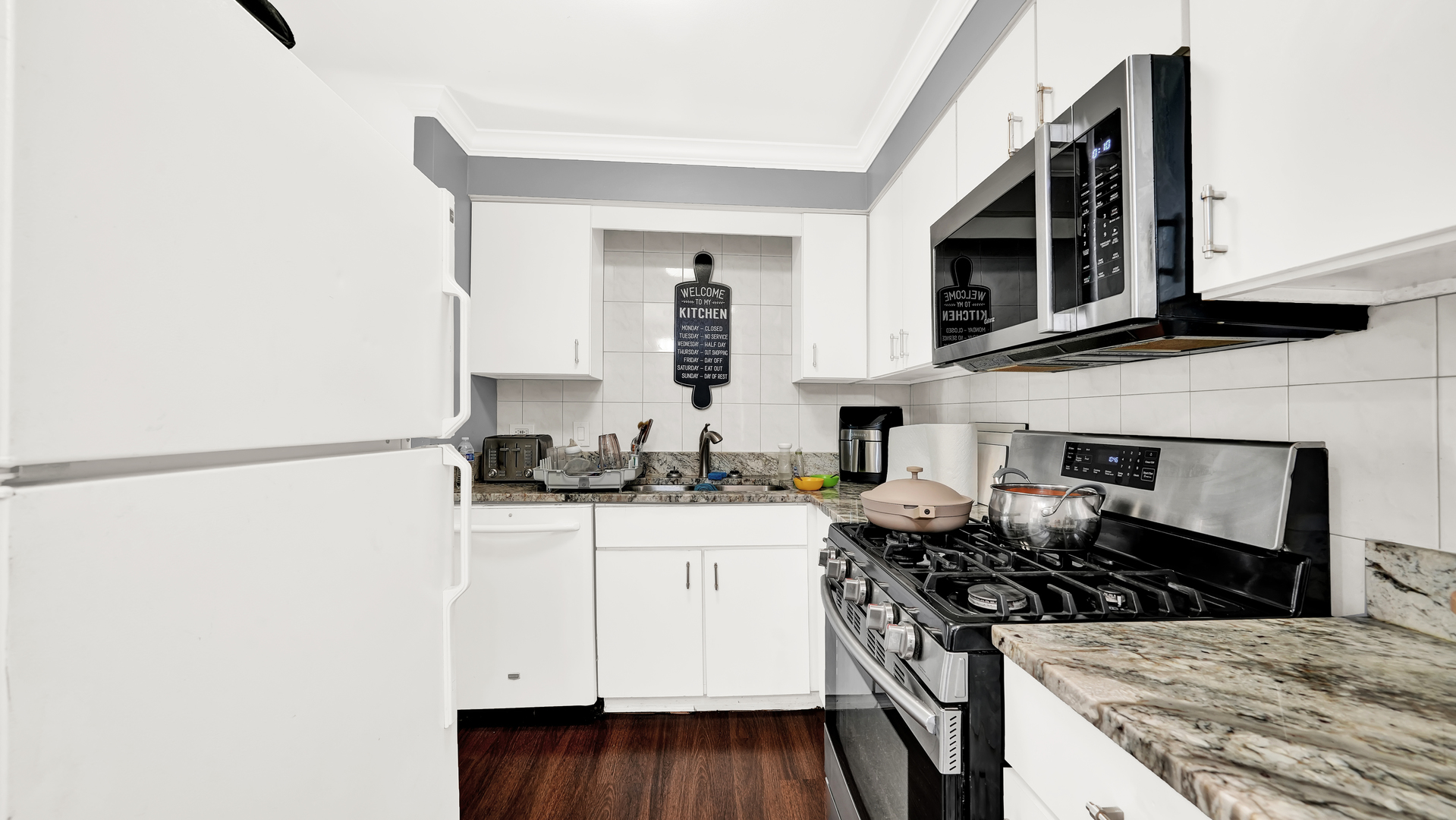 10324 Ridgeland Avenue, Unit 105 Chicago Ridge, IL 60415 - Photo 5 of 11 a kitchen with stainless steel appliances granite countertop a stove and a microwave