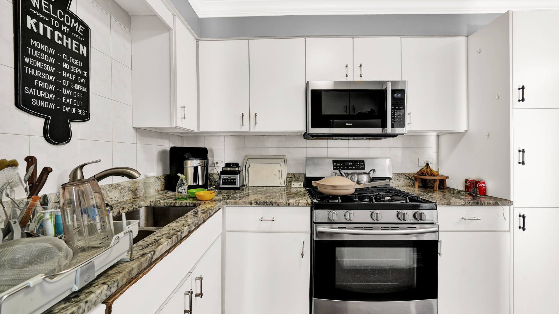 10324 Ridgeland Avenue, Unit 105 Chicago Ridge, IL 60415 - Photo 6 of 11 a kitchen with a stove and a white cabinets
