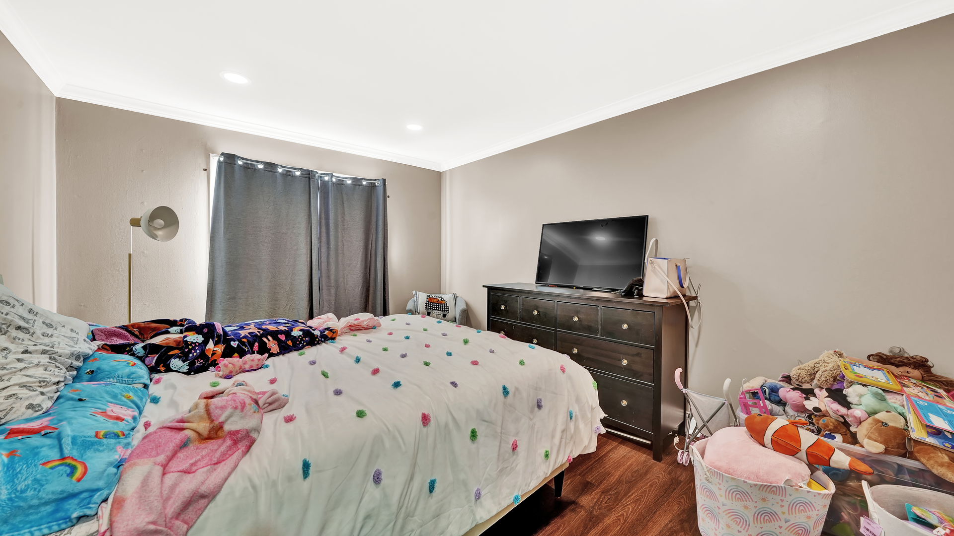 10324 Ridgeland Avenue, Unit 105 Chicago Ridge, IL 60415 - Photo 8 of 11 a bedroom with a bed and a flat screen tv