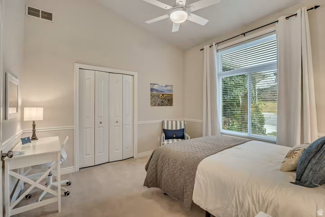 11789 Nicklaus Road Sandy, UT 84092 - Photo 28 of 58 Bedroom with light carpet, lofted ceiling, ceiling fan, and a closet