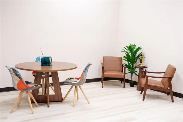 a dining room with furniture and wooden floor