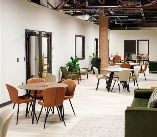 a view of a livingroom and dining room with furniture window and wooden floor