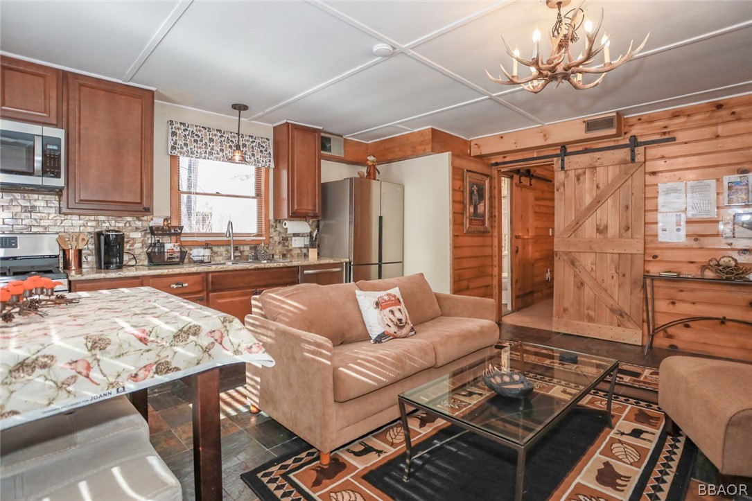 39016 1/2 Robin Road Big Bear Lake, CA 92315 - Photo 11 of 23 a living room with furniture and a chandelier